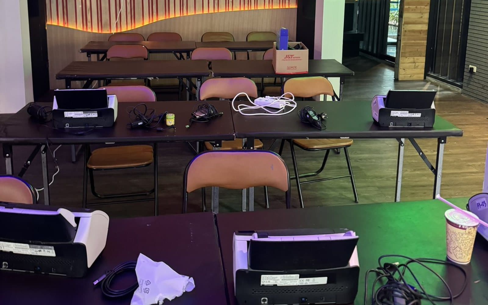 Several document scanners set up on tables for high-volume scanning